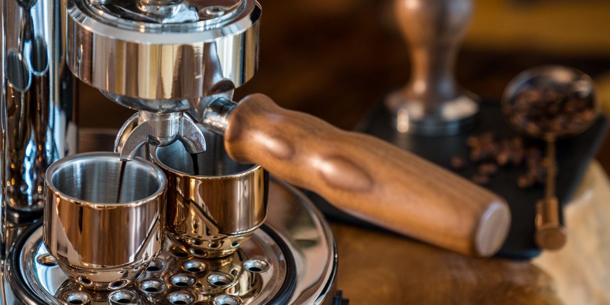 Pouring fresh espresso with high end Barista Espresso Machine at home