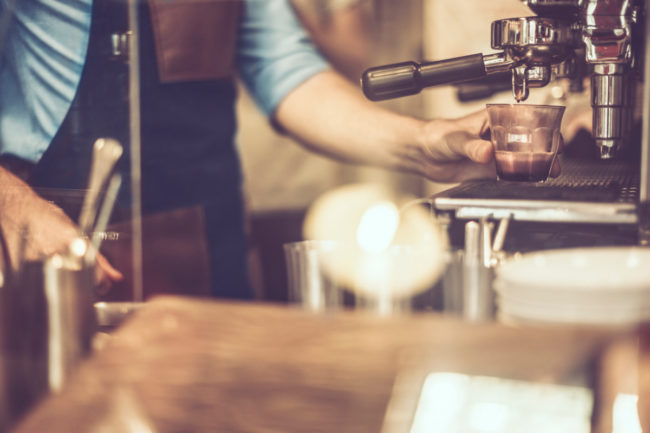 young-barista-is-making-a-coffee young-barista-is-making-a-coffee