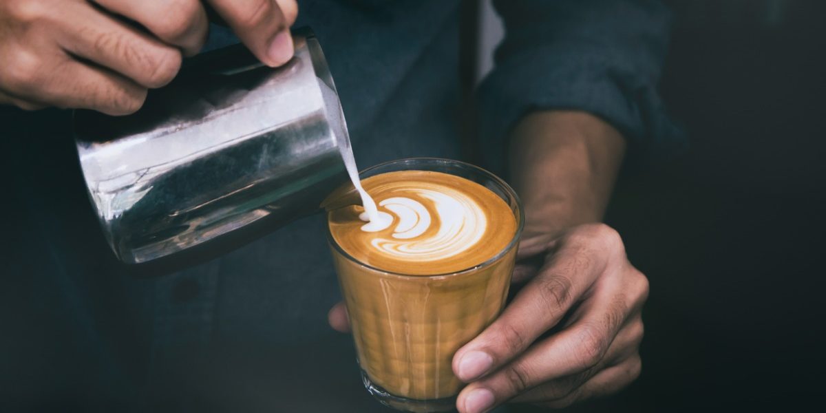 closeup-of-male-barista-hand-holding-and-pouring-hot-milk-for-prepare-picture-id911719976 barista