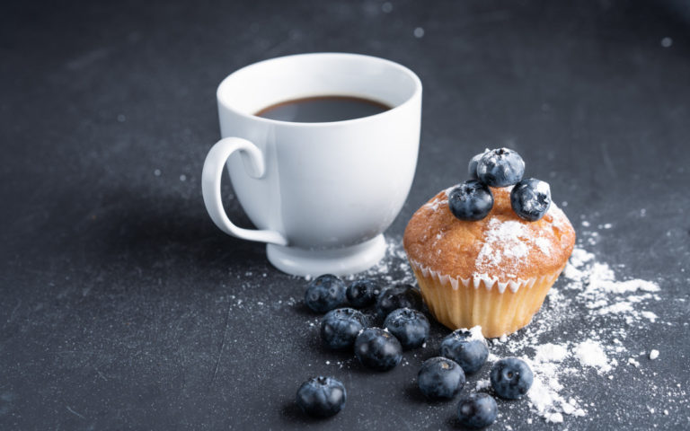 blueberry-antioxidant-organic-superfood-and-sweet-muffin-with-cup-of-picture-id1173342518